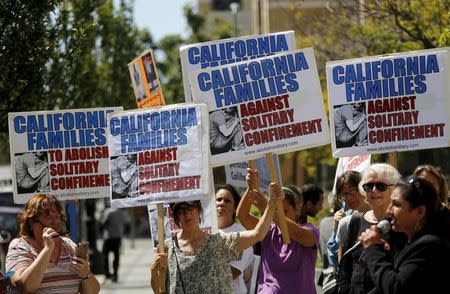 Demonstrators carry signs during a rally at the Elihu Harris state building in Oakland, California, September 1, 2015. REUTERS/Robert Galbraith