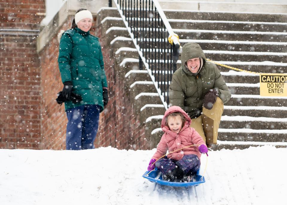 Rochelle and James Turchen, of Doylestown Borough, watch as their daughter, Lorelei, 5, sleds down a hill outside Mercer Museum in Doylestown Borough, during a winter storm that impacted the region on Friday, January 19, 2024.