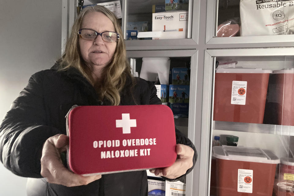 FILE - Debra Cross, director of operations for Provoking Hope, an addiction recovery center in McMinnville, Ore., displays an emergency kit used to treat opioid overdose as she stands inside an ambulance converted into a mobile needle-exchange unit on Dec. 9, 2021. Idaho officials on Friday, May 13, 2022, announced a $119 million settlement with drugmaker Johnson & Johnson and three major distributors over their role in the opioid addiction crisis. The money will address damage wrought by opioids, which the federal government declared a public health emergency in 2017. (AP Photo/Andrew Selsky, File)