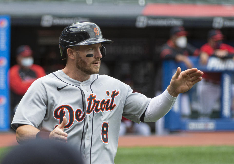 Detroit Tigers' Robbie Grossman celebrates after scoring on an RBI single by Jeimer Candelario during the first inning of a baseball game in Cleveland, Sunday, April 11, 2021. (AP Photo/Phil Long)
