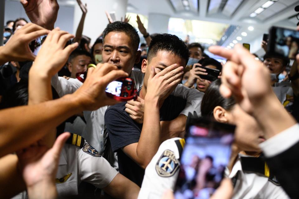 An unidentified man (C) is shouted at by protesters during a demonstration at Hong Kong's International Airport on August 13, 2019. (Photo: Philip Fong/NurPhoto via Getty Images)