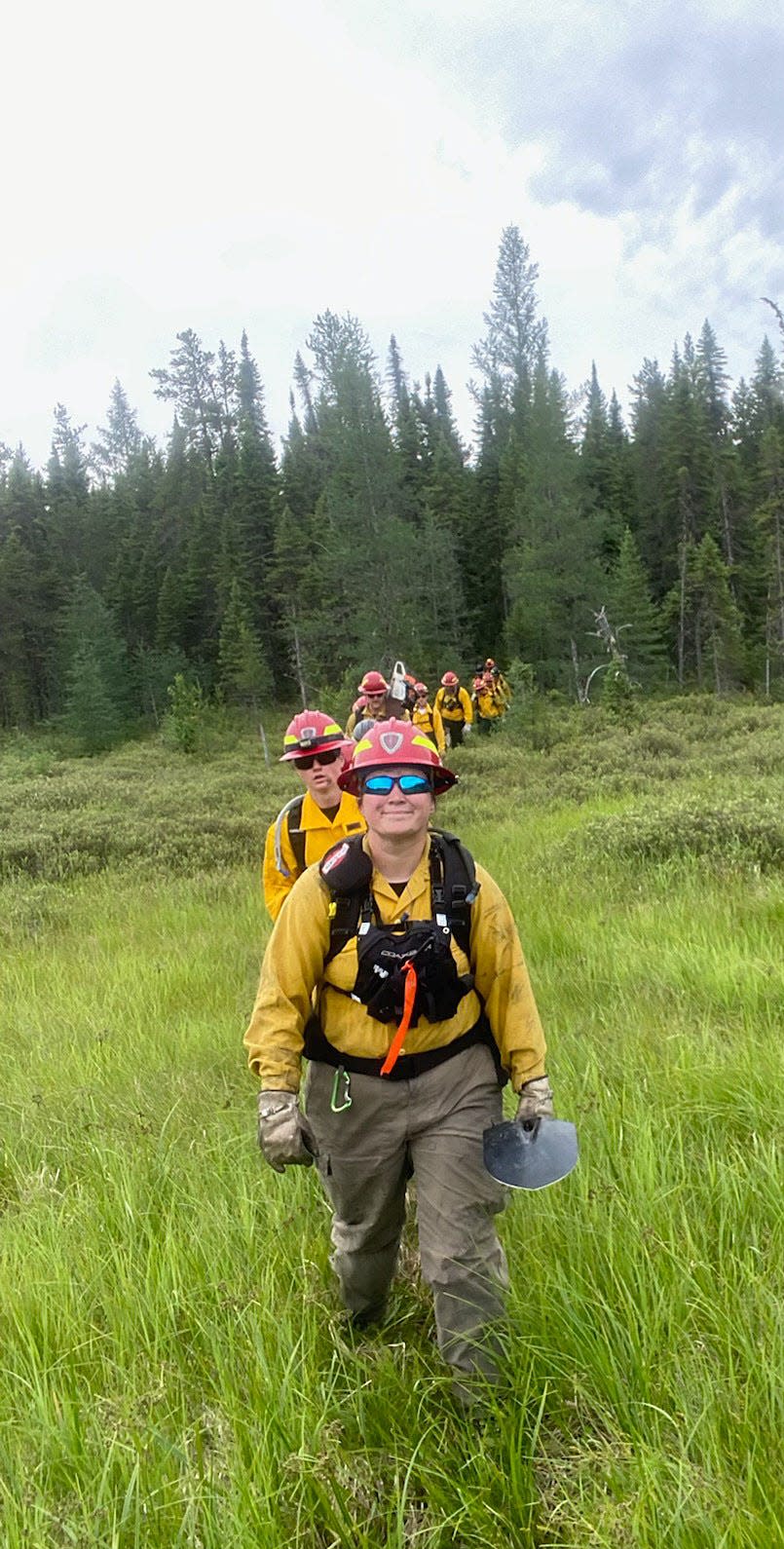 Massachusetts Department of Conservation and Recreation firefighter Nicole Madden, front, and other crew members patrol for hotspots and smoke during their deployment in Normétal, Canada.