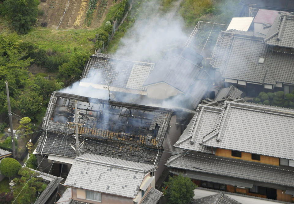 <p>Smoke rises from a house blaze in Takatsuki, Osaka, following an earthquake Monday, June 18, 2018. (Photo: Kyodo News via AP) </p>