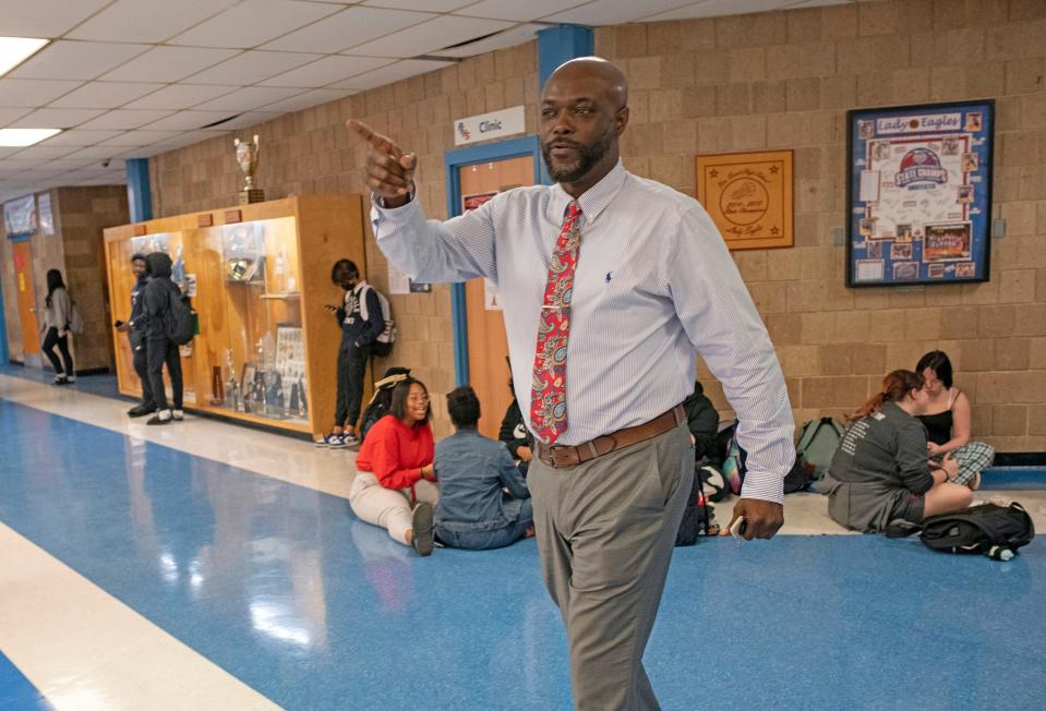 Pine Forest High School Assistant Principal Bakari Franklin monitors student activity in the school hallway during lunch Monday. Franklin is working on a new initiative called "Dads on Duty" to bring positive role models into the school to improve student behavior and culture.