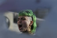 A protester shouts slogans during a rally in Athens, Greece, on Monday Dec. 6, 2021. Hundreds of protesters marched the streets of the Greek capital, on the 13th anniversary of the 15-year old Alexis Grigoropoulos' fatal shooting by the police. (AP Photo/Michael Varaklas)