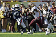 Minnesota running back Mohamed Ibrahim (24) beats Auburn defensive back Roger McCreary (23) to the endzone to score on a 16-yard touchdown run during the first half of the Outback Bowl NCAA college football game Wednesday, Jan. 1, 2020, in Tampa, Fla. (AP Photo/Chris O'Meara)