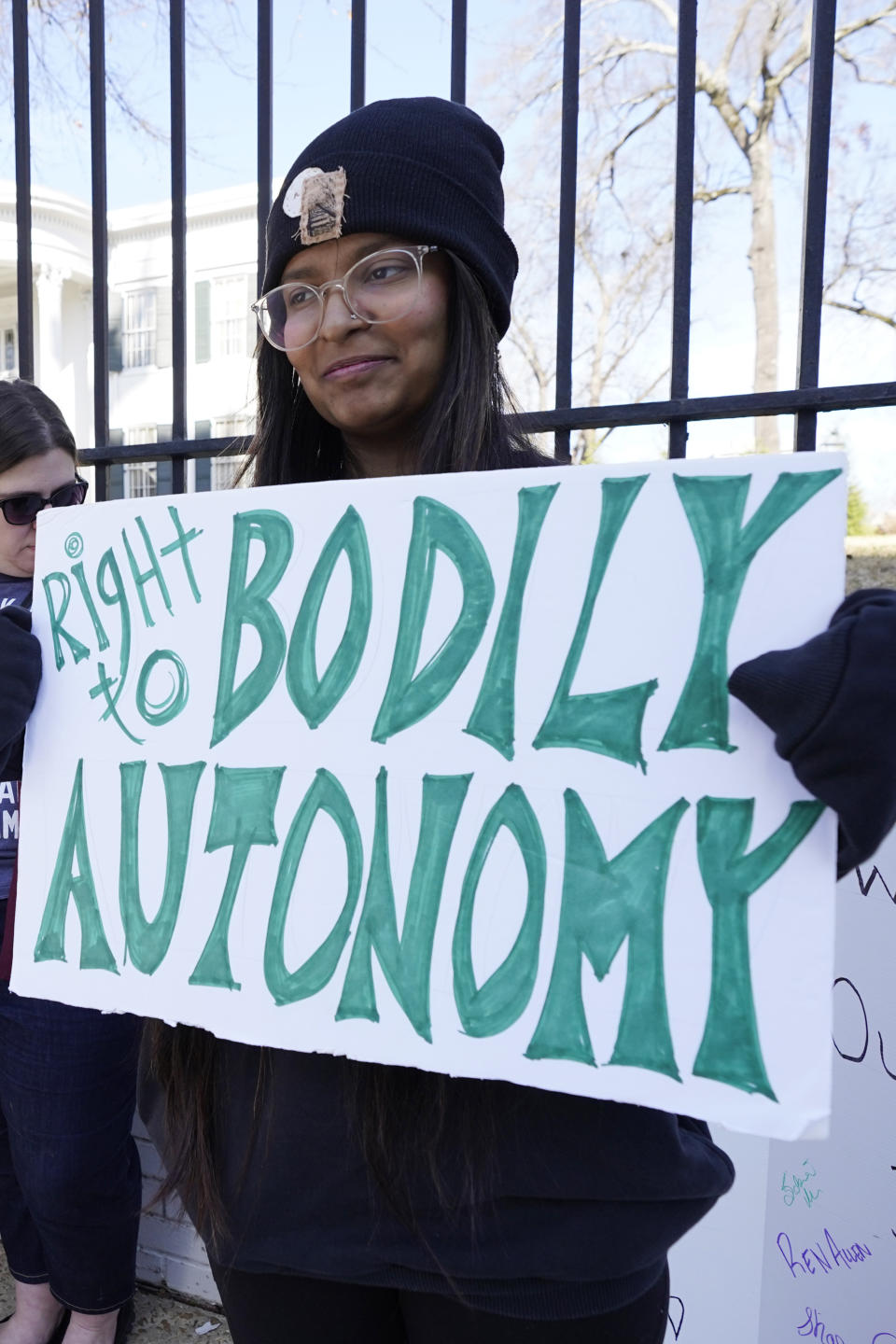 Pradnya Jagdale, a former Jackson abortion clinic escort, stands with a small group of protestors before the Mississippi Governor's Mansion in Jackson, Friday, Jan. 20, 2023. The abortion rights advocates demonstrated at the building's gates, countering the national March For Life gatherings, while carrying signs calling for abortion rights. A state law banning most abortions, went into effect July 7, 2022. (AP Photo/Rogelio V. Solis)