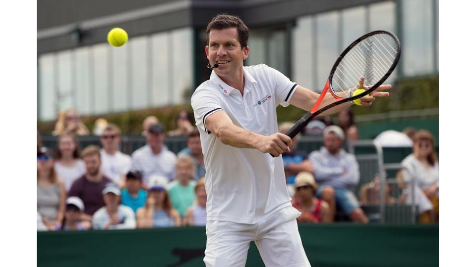 Tim Henman playing tennis