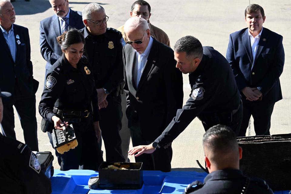 President Joe Biden, making his first trip to the U.S.-Mexico border since he taking office two years ago, listens to U.S. Customs and Border Protection police while examining a fake battery used for smuggling drugs on the Bridge of the Americas border crossing between Mexico and El Paso, Texas.