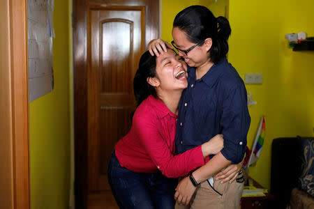 Solo Lee (R), 32, an artist's agent and Lisa Cho, 25, an administrative assistant, pose for a photograph in New Taipei City, Taiwan, May 14, 2017. REUTERS/Tyrone Siu