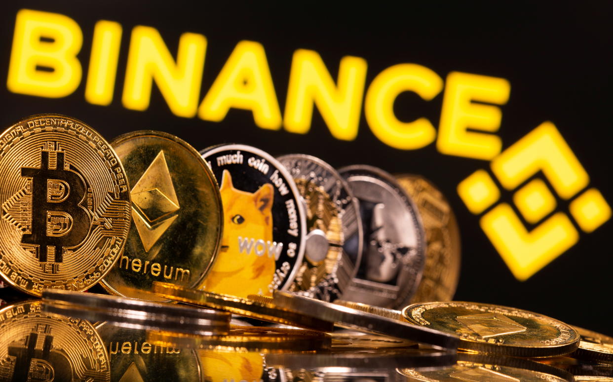 Representations of cryptocurrencies Bitcoin, Ethereum, DogeCoin, Ripple, and Litecoin are seen in front of a displayed Binance logo in this illustration taken, June 28, 2021. REUTERS/Dado Ruvic/Illustration