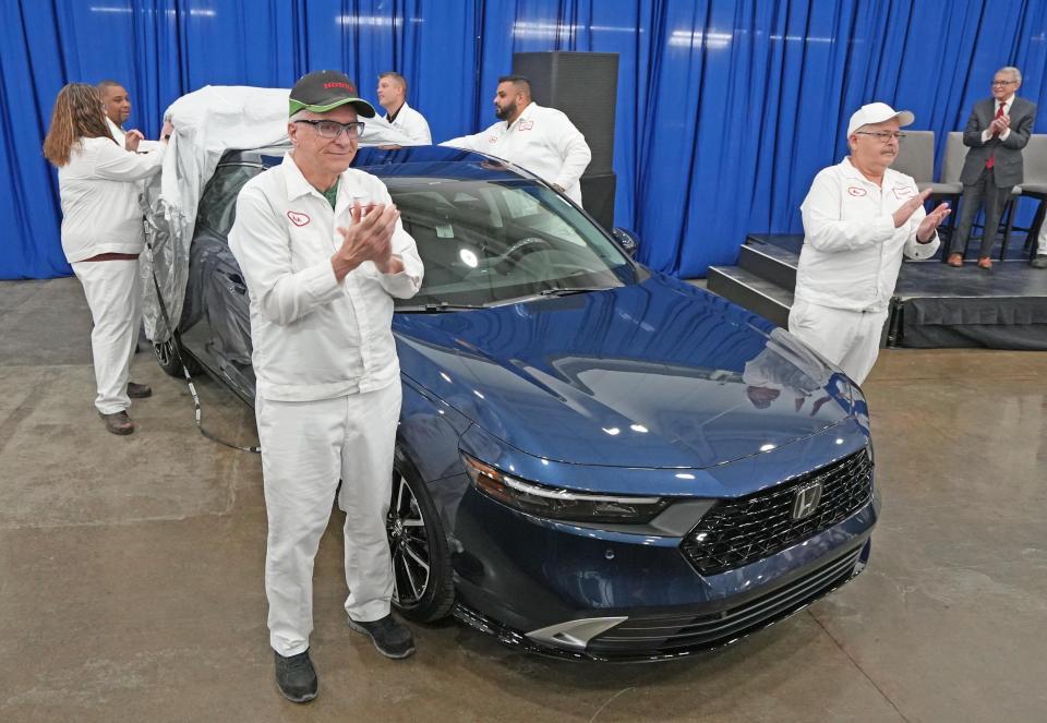 Honda associates Rick VanGundy (front left) and Mike Rausch applaud the new Accord made at the Marysville Auto Plant. Gov. Mike DeWine (right) also attended the unveiling. Pulling the cover off the back of the car is (from left) Melanie Albert, Ken Smith, Zac Latimer and Malov Oza. The event also marked the 40th anniversary of Honda making cars in Ohio.