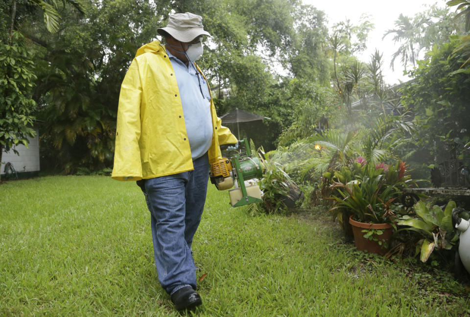 <p>Robert Muxo, of the Miami-Dade County Mosquito Control department, sprays for mosquitoes, Tuesday, June 21, 2016, in Miami. (AP Photo/Lynne Sladky)</p>