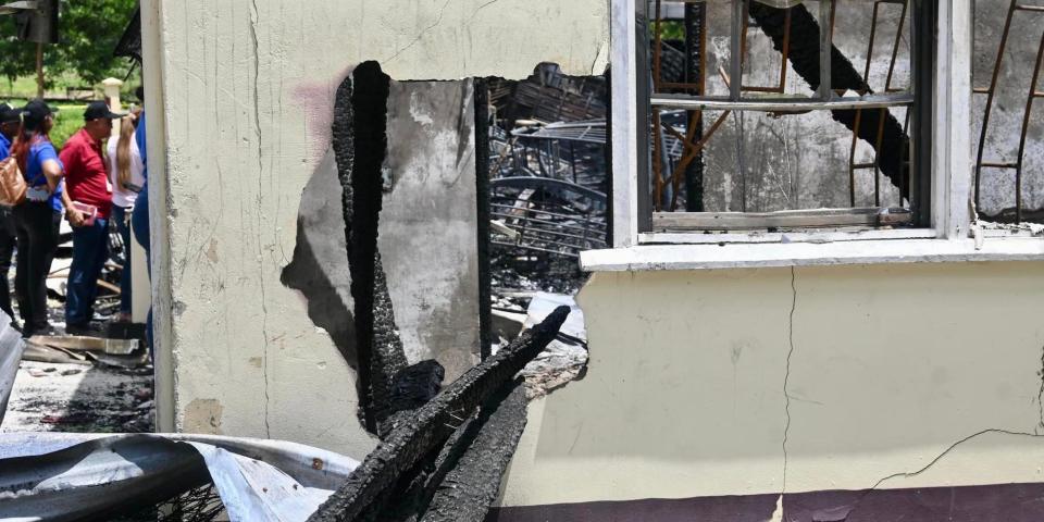 A view of a hole in the side of the dormitory of Mahdia Secondary School in Guyana after a massive blaze on May 21, 2023.