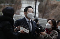 Samsung Electronics Vice Chairman Lee Jae-yong is questioned by reporters upon his arrival at the Seoul High Court in Seoul, South Korea, Monday, Jan. 18, 2021. South Korean court sentences Lee to 2 and a half years in prison over corruption case. (AP Photo/Lee Jin-man)