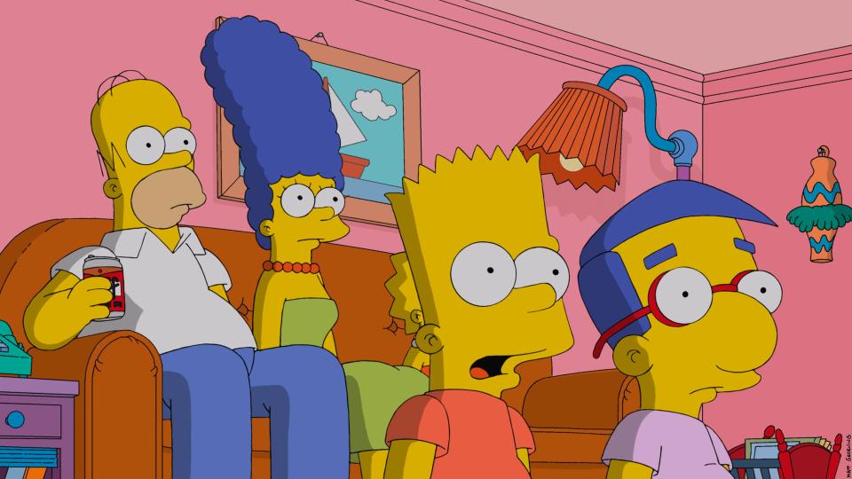 The Simpsons sitting on the couch with Milhouse