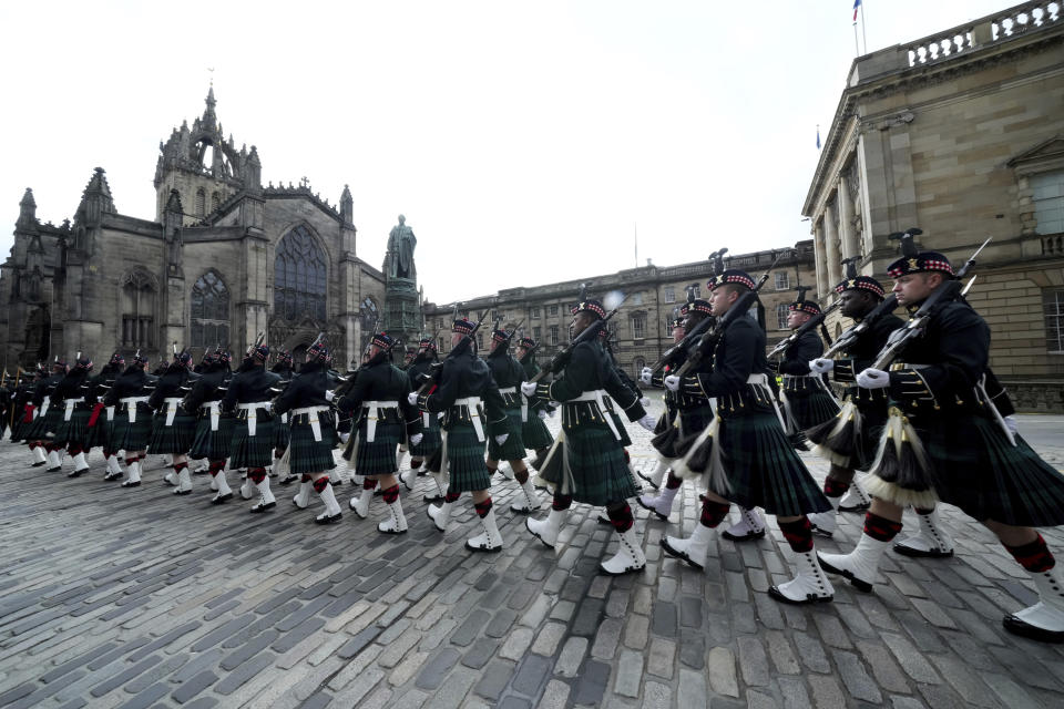 Members of the armed services march near St Giles' Cathedral, in Edinburgh, Scotland, Sunday, Sept. 11, 2022. The Queen's coffin will be transported Sunday on a journey from Balmoral to the Palace of Holyroodhouse in Edinburgh, where it will lie at rest before being moved to London later in the week. (AP Photo/Jon Super)