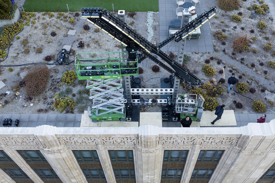 Workers install lighting on an "X" sign atop the company headquarters, formerly known as Twitter, in downtown San Francisco, on Friday, July 28, 2023. San Francisco has launched an investigation into the sign as city officials say replacing letters or symbols on buildings, or erecting a sign on top of one, requires a permit. (AP Photo/Noah Berger)