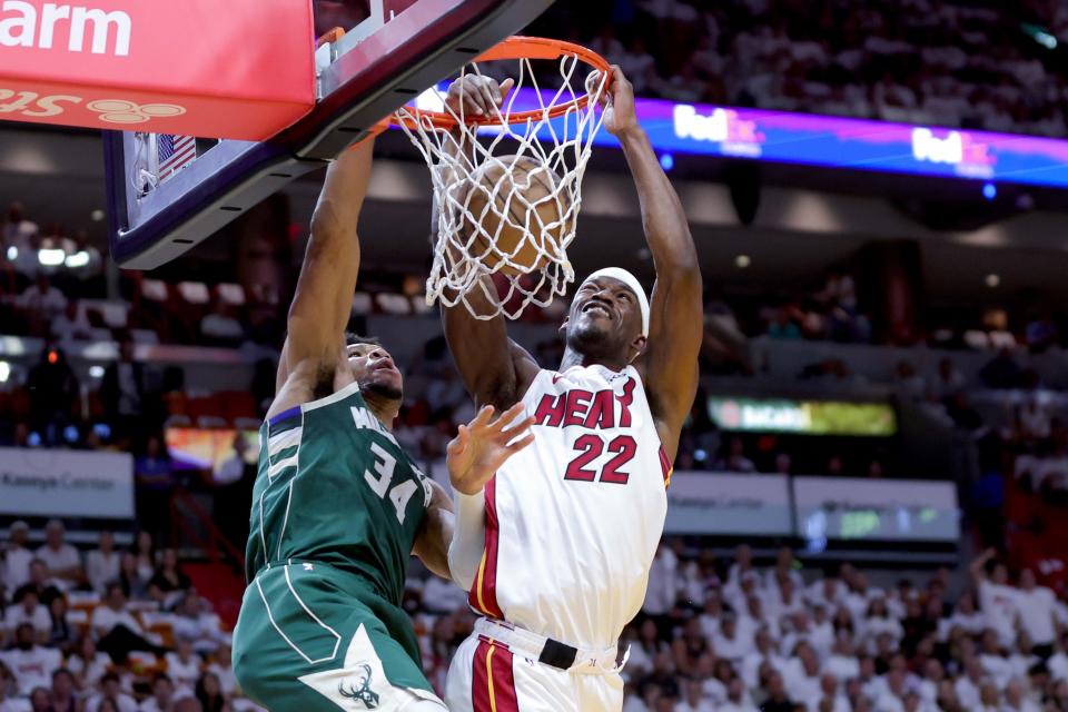 Heat forward Jimmy Butler dunks on Bucks forward Giannis Antetokounmpo during the first quarter of Game 4 on Monday night in MIami. The Bucks had no answer for Butler as he scored a game-high 56 points.