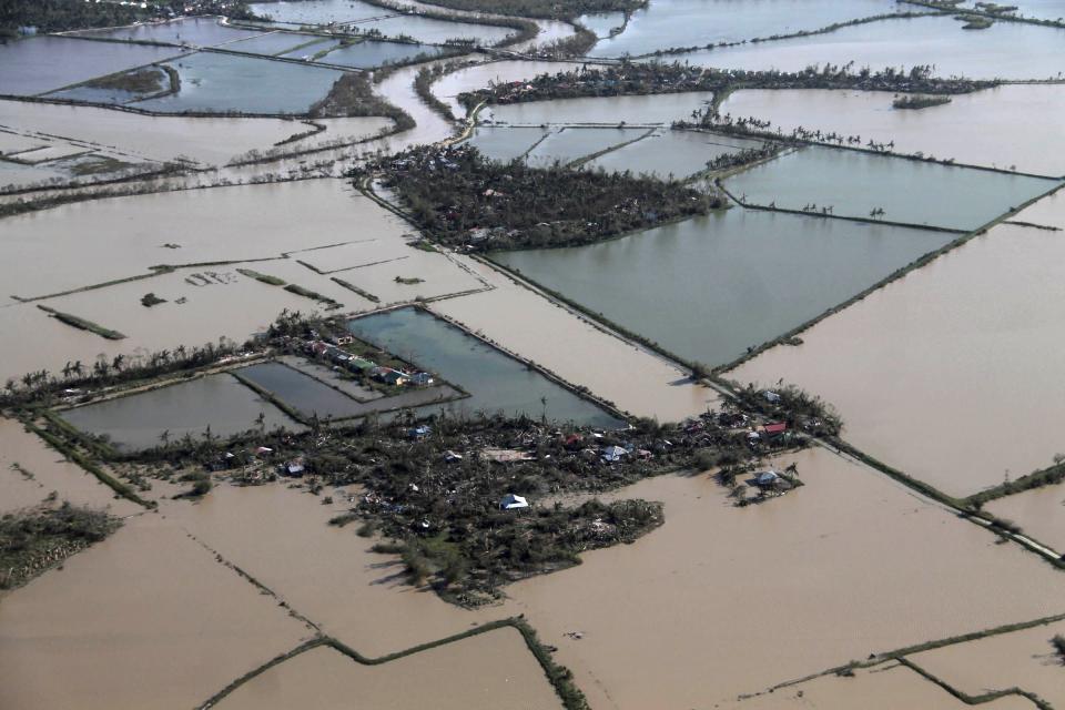 An aerial view shows flooded rice fields after Typhoon Haiyan hit Iloilo Province, central Philippines November 9, 2013. One of the strongest typhoons ever to make landfall devastated the central Philippines, killing more than 1,000 people in one city alone and 200 in another province, the Red Cross estimated on Saturday, as reports of high casualties began to emerge. REUTERS/Leo Solinap (PHILIPPINES - Tags: ENVIRONMENT DISASTER AGRICULTURE BUSINESS)