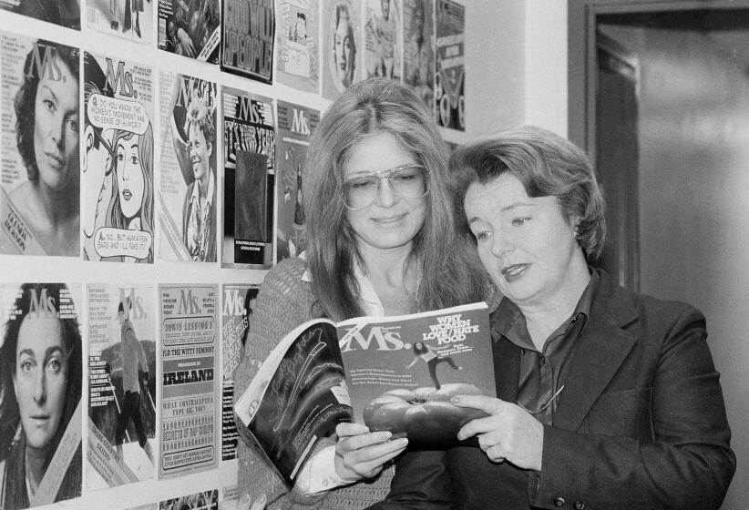 Gloria Steinem, left, and Pat Carbine, two of Ms. magazine's founding editors, look through a copy of the magazine at Ms. offices on Jan. 29, 1980.