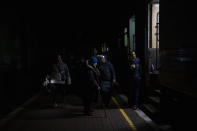 Ukrainians board the Kherson-Kyiv train at the Kherson railway station, southern Ukraine, Saturday, Nov. 26, 2022. Fleeing shelling, hundreds of civilians on Saturday streamed out of the southern Ukrainian city whose recapture they had celebrated just weeks earlier. (AP Photo/Bernat Armangue)