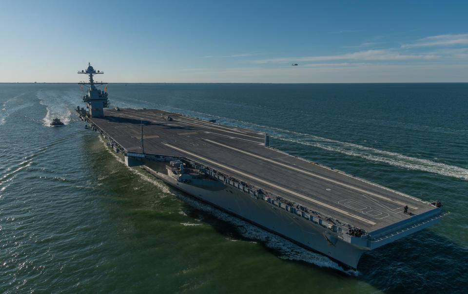 Aircraft carrier USS Gerald R. Ford steams in open waters.