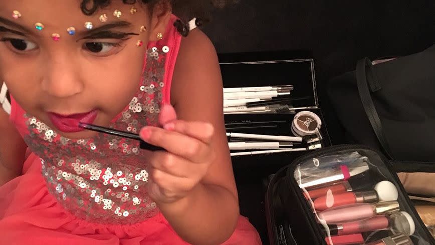 Blue trying on some makeup in a photo from her mama's Instagram. Source: Instagram