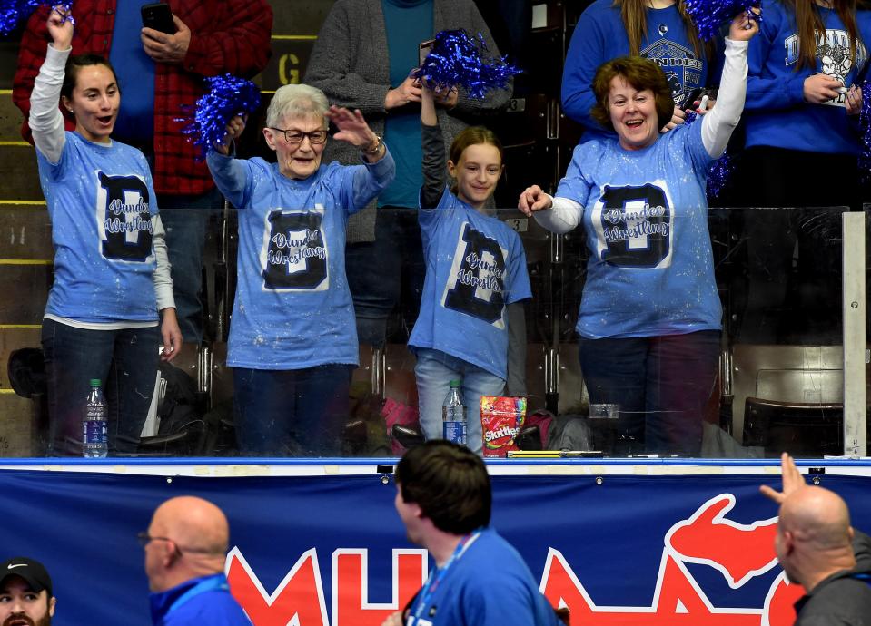 Theresa Dalton cheered on her son head coach Tim Roberts (waving up), along with her granddaughter Hana Parker, great granddaughter Sophia, 9, and her daughter Bridget White at they took part in the grand march in the Division 3 state quarterfinals, semifinals and finals at the Wings Event Center in Kalamazoo 2022.