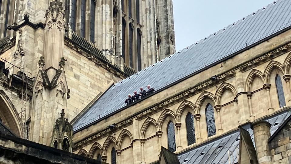 The firefighters pictured on the roof of the Minster
