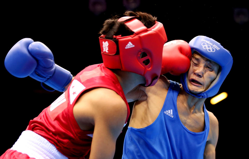 LONDON, ENGLAND - AUGUST 04: Birzhan Zhakypov of Kazakhstan (R) in action with Mark Barriga of Philippines during the Men's Light Fly (46-49kg_ Boxing on Day 8 of the London 2012 Olympic Games at ExCeL on August 4, 2012 in London, England. (Photo by Scott Heavey/Getty Images)