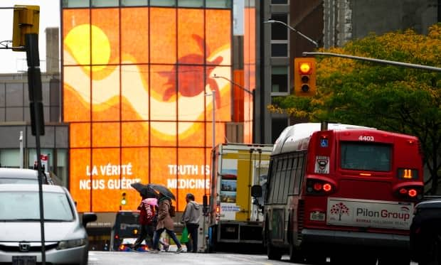 A large screen on the National Arts Centre displays a message of 'Truth Is Medicine' in Ottawa on Monday, Sept. 27, 2021. The first National Day for Truth and Reconciliation will be observed on Sept., 30, 2021. (Sean Kilpatrick/Canadian Press - image credit)