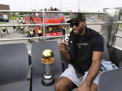 Toronto Raptors forward Kawhi Leonard smokes a cigar as he sits with his playoffs MVP trophy during the 2019 Toronto Raptors NBA basketball championship parade in Toronto, Monday, June 17, 2019. (Photo by Frank Gunn/The Canadian Press via AP)