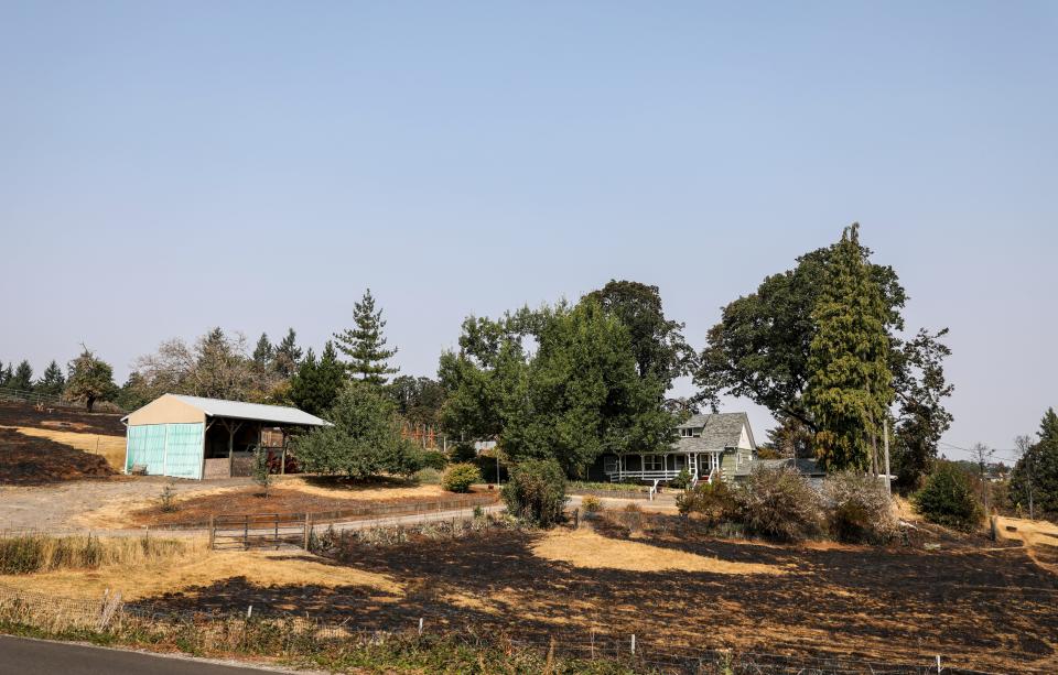 Burn scars mark property near a home near Jory Hill Road South in the aftermath of the Liberty Fire on Aug. 23.