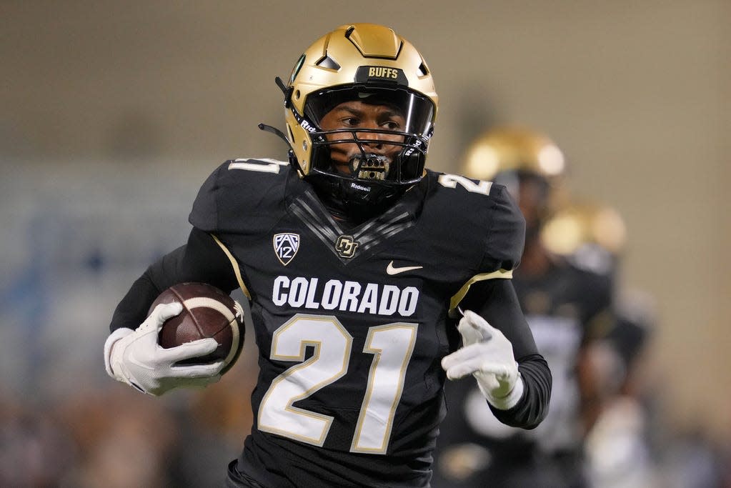 Colorado Buffaloes safety Shilo Sanders (21) runs for a touchdown after making an interception against the Colorado State Rams during the first half at Folsom Field in Sept. 2023.