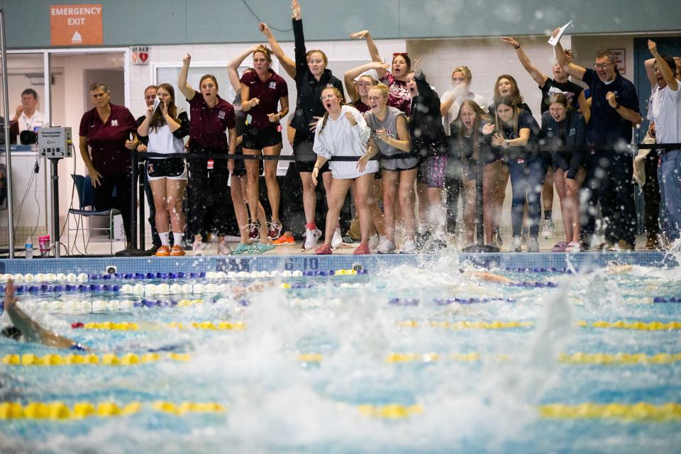 Holland Christian cheer on their teammates during the D3 state title meet Saturday, Nov. 19, 2022, at The Holland Aquatic Center.