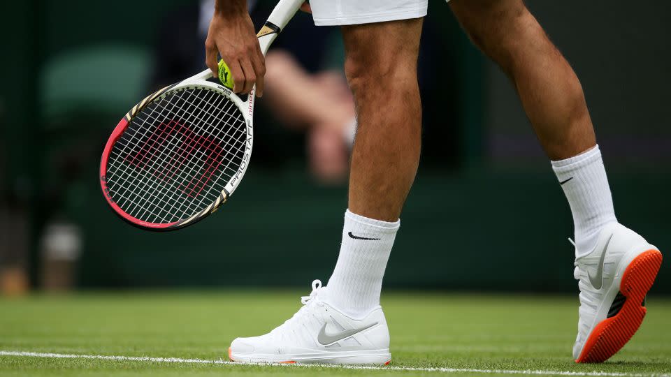 Roger Federer’s orange-soled Nike sneakers were banned from Wimbledon after his first-round match in 2013, and the following year the rules tightened for color accents. - Clive Brunskill/Getty Images