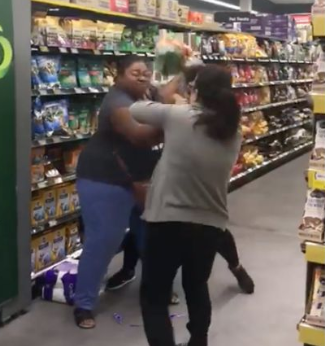 Shoppers were caught on video in a scrap of toilet paper inside Woolworths on the weekend. Source: Facebook