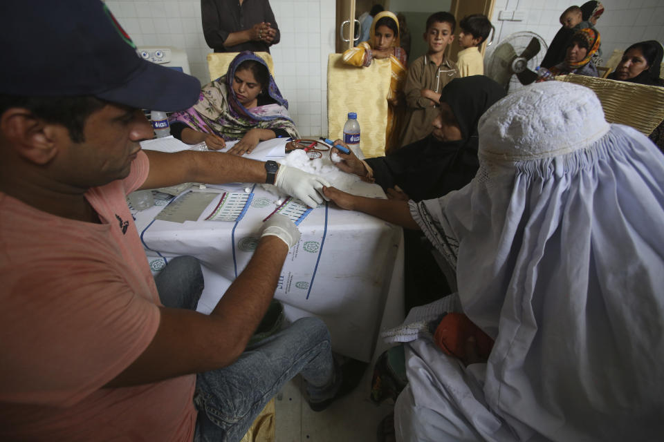 A Pakistani doctor screens villagers for HIV at a hospital in a village near Ratodero, a small town in southern province of Sindh in Pakistan where the outbreak of deadly disease took place last month, Thursday, May 16, 2019. Officials say about 500 people, mostly children, have tested positive for HIV, the virus that causes AIDS, in a southern Pakistani provincial district. A local doctor who has AIDS has since been arrested and is being investigated for possibly intentionally infecting patients. (AP Photo/Fareed Khan)