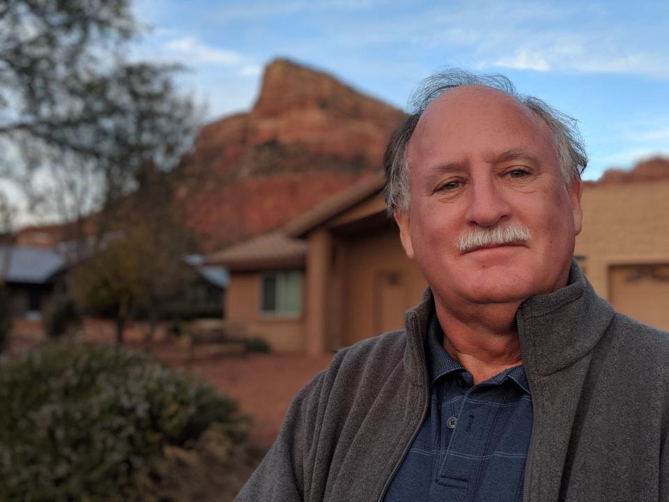 Sedona City Councilmember Scott Jablow stands in front of a home being operated as a short-term rental. City officials and residents say the law has exacerbated a growing problem of unavailable housing that could have far-reaching consequences for their city.