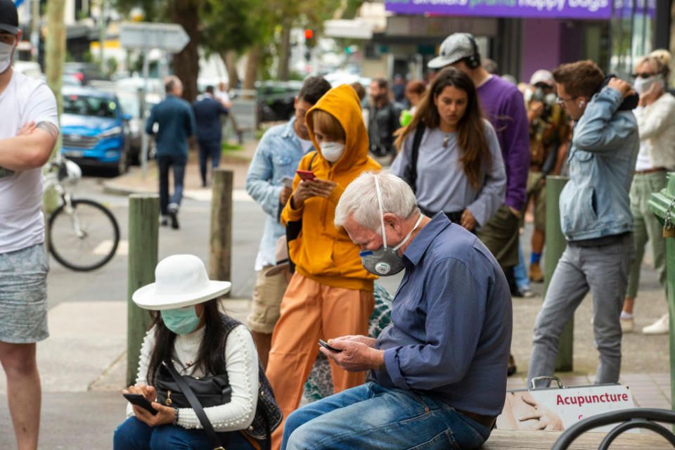 People are seen lining up at Centrelink in Bondi Junction.