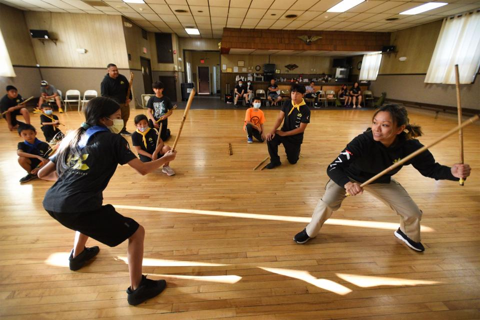 Lakan Guro Kris Ramirez, R, demonstrates with a student during the Filipino Kale Martial Arts at Kali Academy in Bergenfield, Monday on 06/13/22.