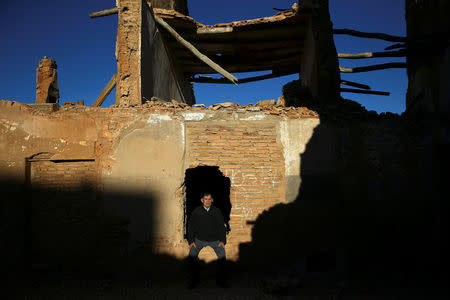 Tomas Ortin, 94, survivor of the Belchite battle, poses for a picture at the ruins of his former home in the old village of Belchite, in northern Spain, November 14, 2016. REUTERS/Andrea Comas