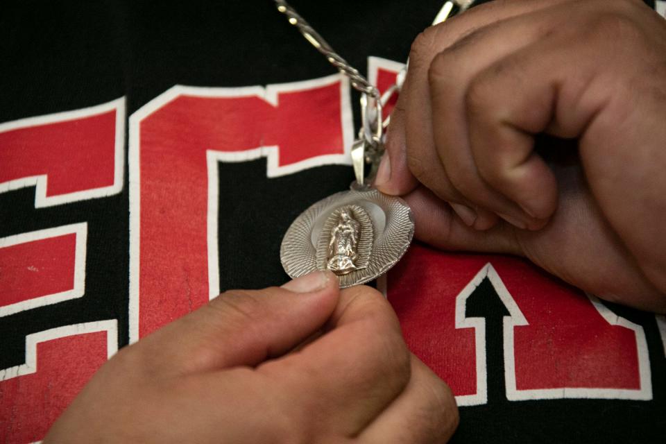 Jorge Garcia, 41, prayed every day he lived his two year deported life in Mexico. He shows a pendant with the Lady of Guadalupe on one side and Jesus on the other. A press conference was held with Rep. Debbie Dingell, D-Dearborn, to welcome once deported Jorge Garcia back to the U.S. and his family at the Lincoln Park Library Friday, Jan. 10, 2020.