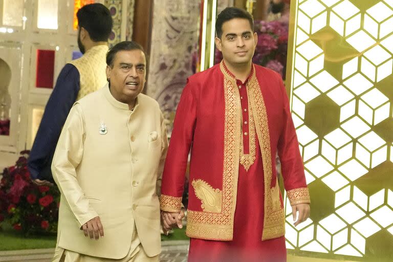 El presidente de Reliance Industries Limited, Mukesh Ambani, izquierda, y su hijo Akash Ambani posan durante la ceremonia previa a la boda del hijo menor de Ambani, Anant Ambani, con Radhika Merchant, en su residencia Antilia en Mumbai, India, el lunes 8 de julio de 2024