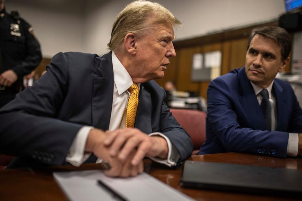 Former President Donald Trump sits in the courtroom next to his lawyer Todd Blanche shortly before the defense rested its case Tuesday, May 21 (AP)