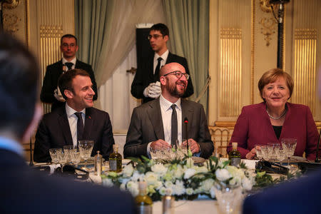 FILE PHOTO - Belgian Prime Minister Charles Michel sits between French President Emmanuel Macron and Germany's Chancellor Angela Merkel during a dinner with European Union leaders at Val Duchesse castle in Brussels, Belgium, February 22, 2018. Chancellerie du Premier ministre/Belgian Prime Minister Office/Handout via REUTERS