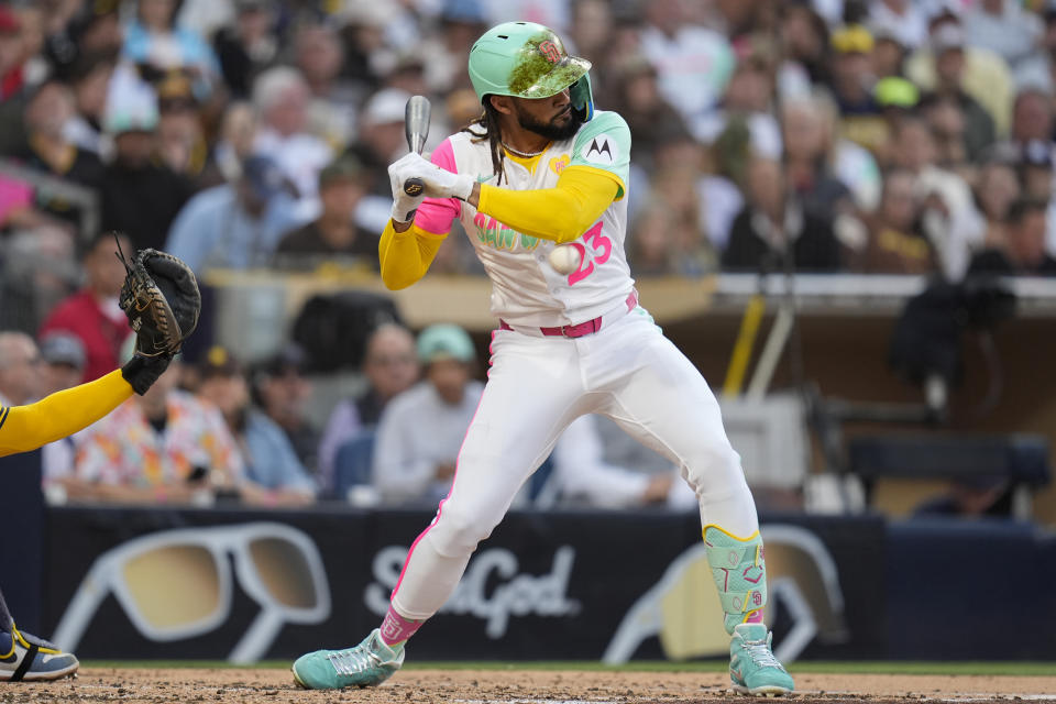 San Diego Padres' Fernando Tatis Jr. is hit by a pitch during the third inning of a baseball game against the Milwaukee Brewers, Friday, June 21, 2024, in San Diego. (AP Photo/Gregory Bull)