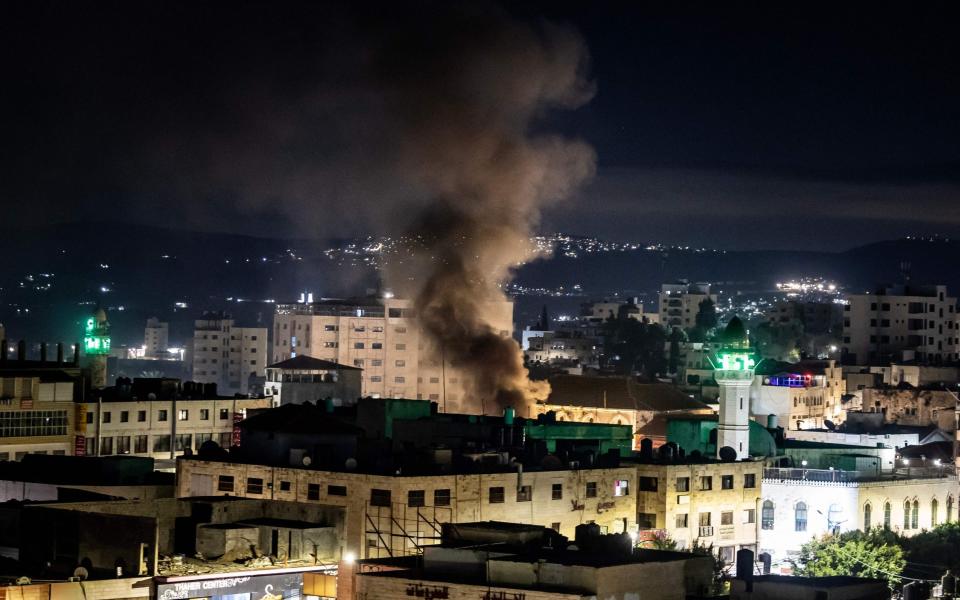 Smoke raises during a raid in the occupied West Bank Jenin refugee camp