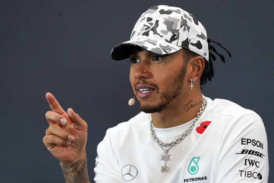 FILE - In this Nov. 3, 2019, file photo, Mercedes driver Lewis Hamilton, of Britain, speaks during a news conference following the Formula One U.S. Grand Prix auto race at the Circuit of the Americas, Sunday,, in Austin, Texas. Driving around Formula One tracks without fans cheering loudly at Silverstone and Monza would literally feel “very empty” for world champion Lewis Hamilton. The first 10 races this season have been postponed or canceled amid the coronavirus pandemic, and if F1 does start this summer no fans can watch. (AP Photo/Chuck Burton, File)